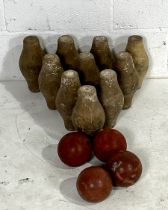 A vintage set of ten wooden skittles along with four rubber skittle balls