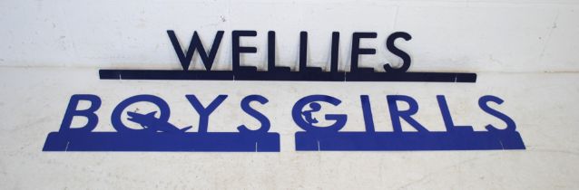 Three blue metal signs, reading 'Boys', 'Girls' and 'Wellies'