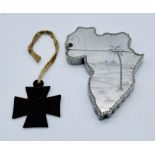 A vintage "Souvenir of Egypt" lighter in the form of a map of Africa along with a small iron cross