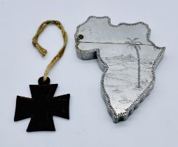 A vintage "Souvenir of Egypt" lighter in the form of a map of Africa along with a small iron cross