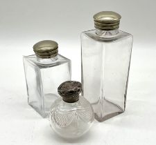 A silver topped scent bottle plus two silver plated topped scent bottles.