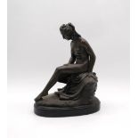 A bronzed figure of a nude lady, signed 'Callegrain' - length 24cm, height 32cm