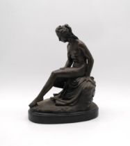 A bronzed figure of a nude lady, signed 'Callegrain' - length 24cm, height 32cm