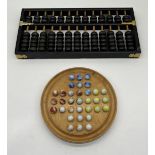 A vintage Chinese Lotus Flower abacus along with a Jaques marble Solitaire game.