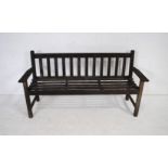 A weathered wooden slatted garden bench, possibly Lister - length 158cm