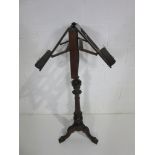 A turn of the century double sided adjustable music stand