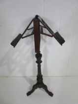 A turn of the century double sided adjustable music stand