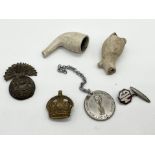 A small collection of items including a Royal Munster Fusiliers cap badge