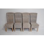 A set of four rattan dining chairs, with cushions