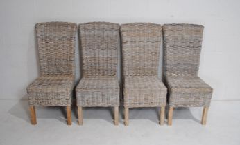 A set of four rattan dining chairs, with cushions