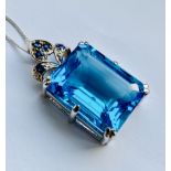 A 9ct white gold pendant and chain set with a large swiss blue topaz of 24.847ct weight (20mmx