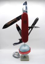 A large Victorinox Swiss Army Knife articulated display stand - red central band A/F - height 82cm