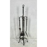 A Blacksmith forged companion set comprising of poker, tongs, brush and shovel. Height 111cm