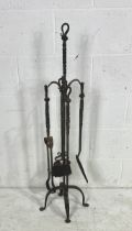 A Blacksmith forged companion set comprising of poker, tongs, brush and shovel. Height 111cm