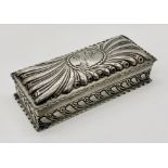 A hallmarked silver box with repousse decoration