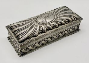 A hallmarked silver box with repousse decoration