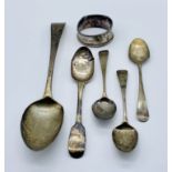 A small collection of hallmarked silver spoons along with a damaged silver napkin ring, total weight