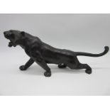 A Meiji period Japanese bronze figure of a tiger with patinated stripes, character marks to