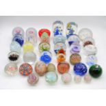 A collection of various art glass paperweights