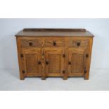 An oak sideboard, with three drawers and cupboard under - length 137.5cm, depth 45cm, height 93cm