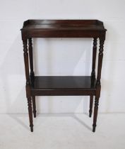 A Victorian mahogany two tier whatnot, with gallery tray, raised on turned legs and supports -