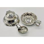 A hallmarked silver inkwell (A/F) along with a small silver leaf shaped wine taster and a silver