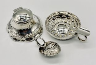 A hallmarked silver inkwell (A/F) along with a small silver leaf shaped wine taster and a silver