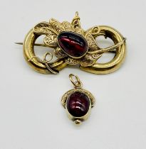 A 9ct gold (tested) Victorian brooch set with a cabochon garnet set on an oak leaf along with a
