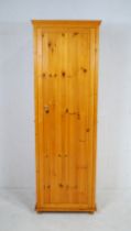 A pine single wardrobe - length 62cm, depth 57cm, height 186cm