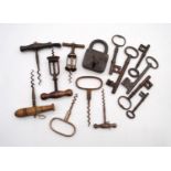 A small collection of antique keys and padlock, along with a small collection of corkscrews