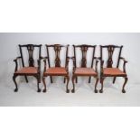 A set of four Hepplewhite style carver chairs raised on claw and ball feet