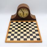 A vintage mantel clock, along with a chess board