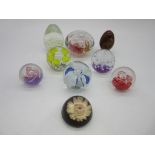 A small collection of glass paperweights etc.