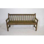 A weathered wooden slatted garden bench - length 153cm