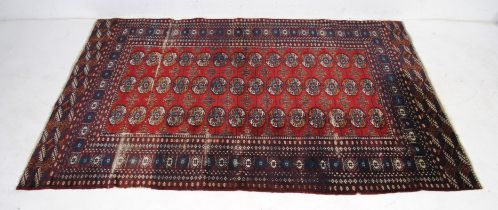 A red ground Eastern rug - some wear - 190cm x 125cm