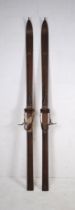 A pair of vintage wooden skis, marked 'J. E. H.'