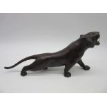A Japanese Meiji period bronze figure of a tiger with patinated stripes, length 29cm