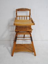 A vintage wooden child's metamorphic high chair