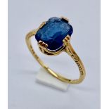 An 18ct gold ring set with a blue stone