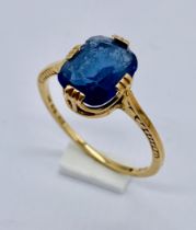 An 18ct gold ring set with a blue stone