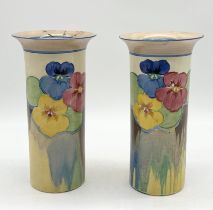 A pair of Clarice Cliff Bizarre waisted cylindrical vases in the "Pansies" pattern, shape number 195