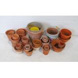 A quantity of various sized terracotta garden pots