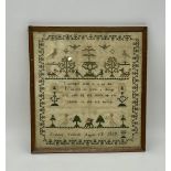 An antique sampler decorated with trees, animals and a verse "I wonder what it is to die, it seems