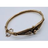 A turn of the century unmarked 9ct rose gold hinged bracelet, weight 8.8g