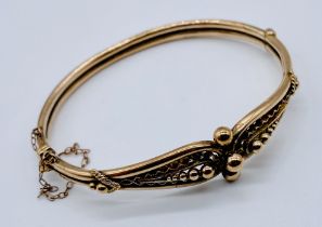 A turn of the century unmarked 9ct rose gold hinged bracelet, weight 8.8g