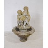 A weathered reconstituted stone sectional garden water fountain, the top in the form of two