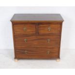 A Georgian mahogany chest of four drawers of small proportions, raised on replacement bun feet -