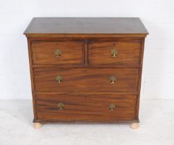 A Georgian mahogany chest of four drawers of small proportions, raised on replacement bun feet -