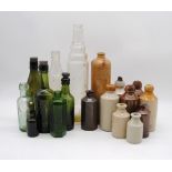 A collection of glass bottles and stoneware jars, including 'Shelvey & Co Ltd' of Brighton, 'W. Dove