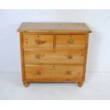 An antique pine chest of four drawers, raised on turned feet - length 92cm, depth 45cm, height 84cm
